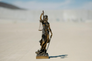 A miniature statue representing the law and legal defense.