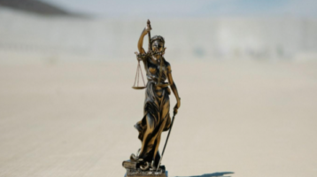 A miniature statue representing the law and legal defense.